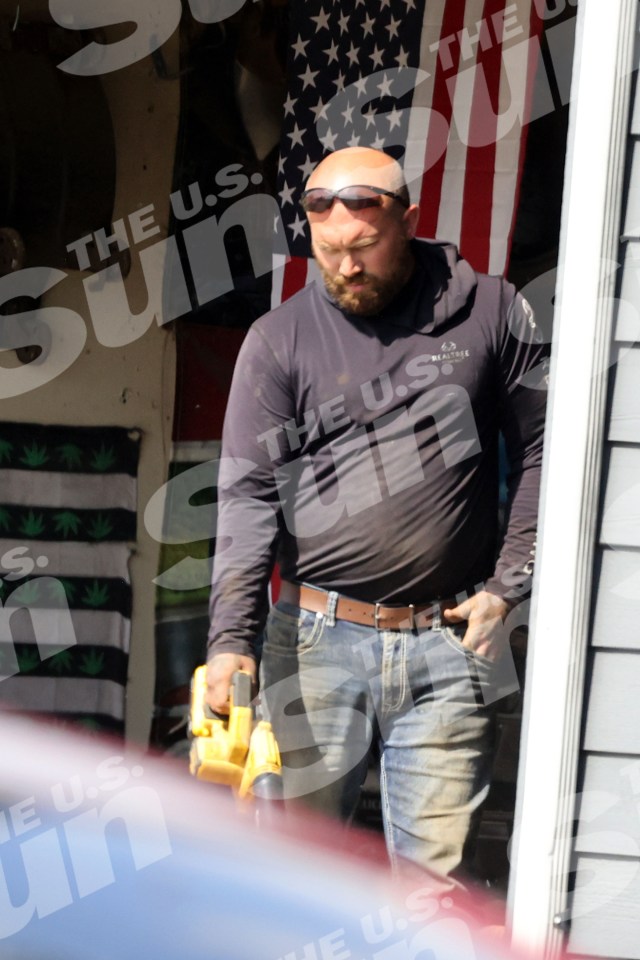 Adam Lind, Teen Mom star, using a leaf blower outside his home.