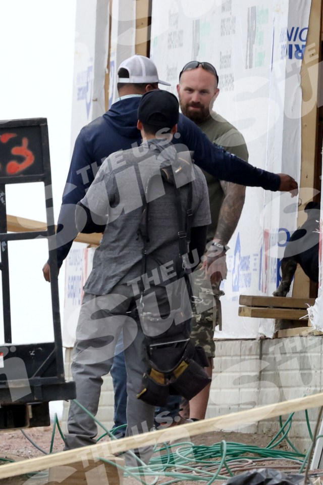 Adam Lind at a construction site with his dog.