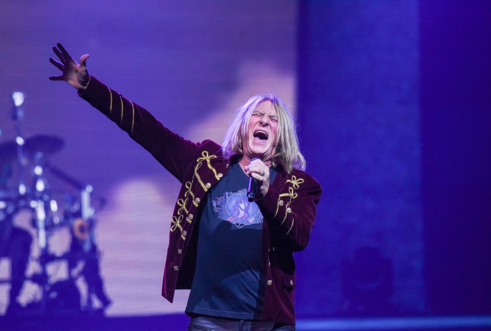 Joe Elliott of Def Leppard performing on stage.