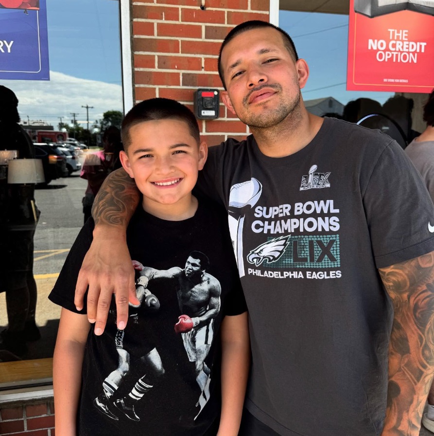 Man and boy posing for a photo.