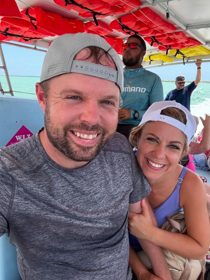 Couple smiling on a boat.