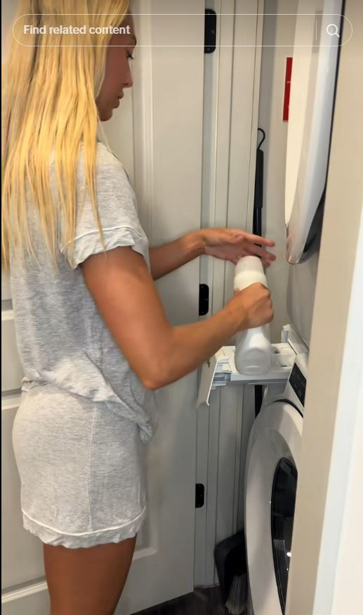 Woman adding laundry detergent to a washing machine.