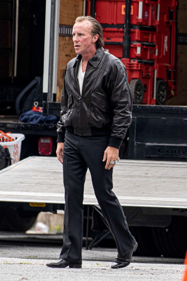 Christian Bale on the set of "Madden," wearing a leather jacket and three Super Bowl rings.