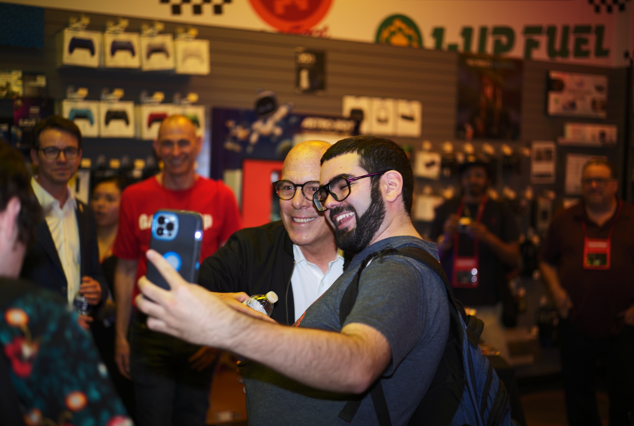 Doug Bowser (left) poses with a fan (right)