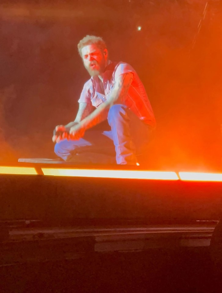 Post Malone performing on stage.