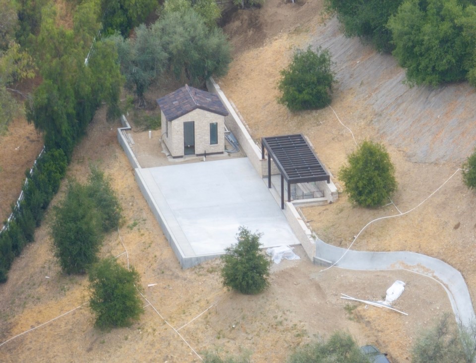Aerial view of Kylie Jenner's unfinished Hidden Hills mansion grounds, showing a small building and paved patio area under construction.