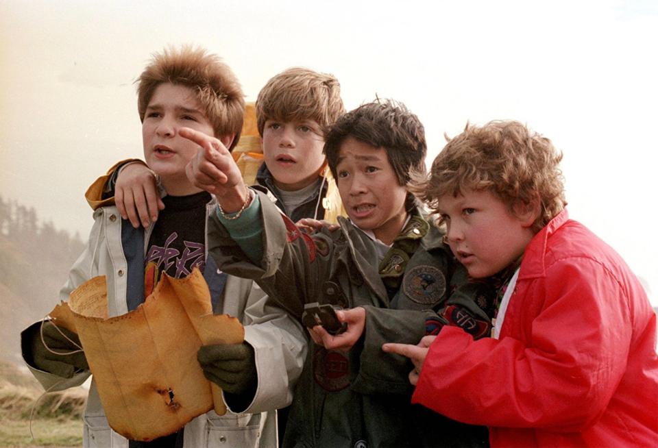 The Goonies looking at a treasure map.