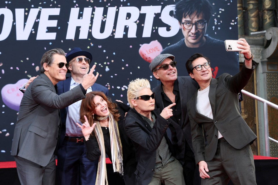 Group photo of actors taking a selfie.