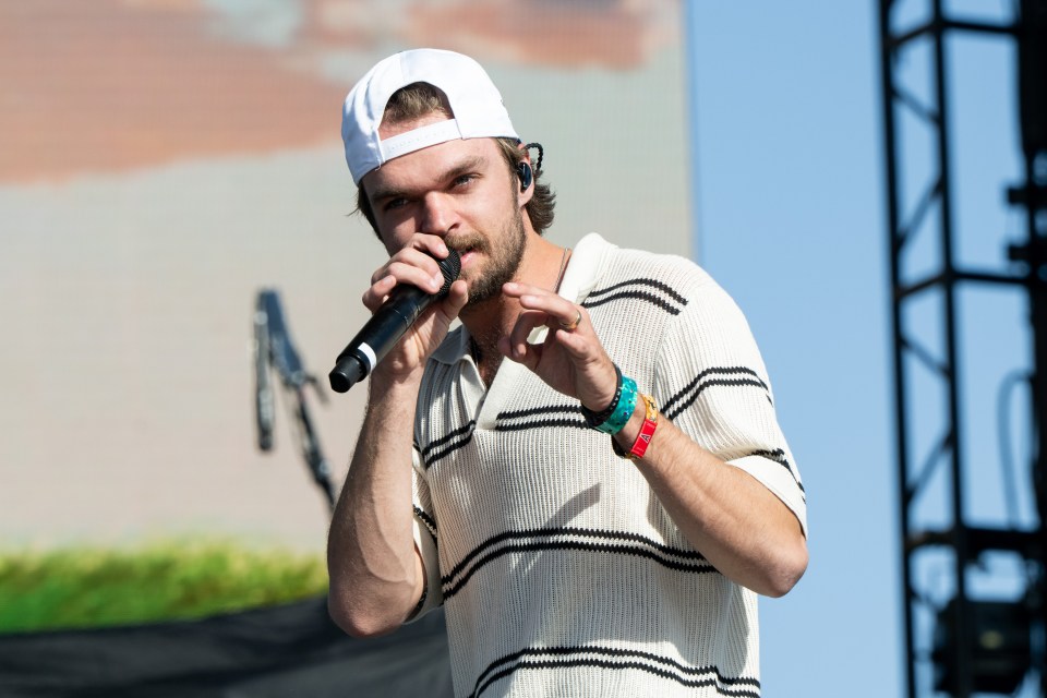 Singer Conner Smith performing on stage.