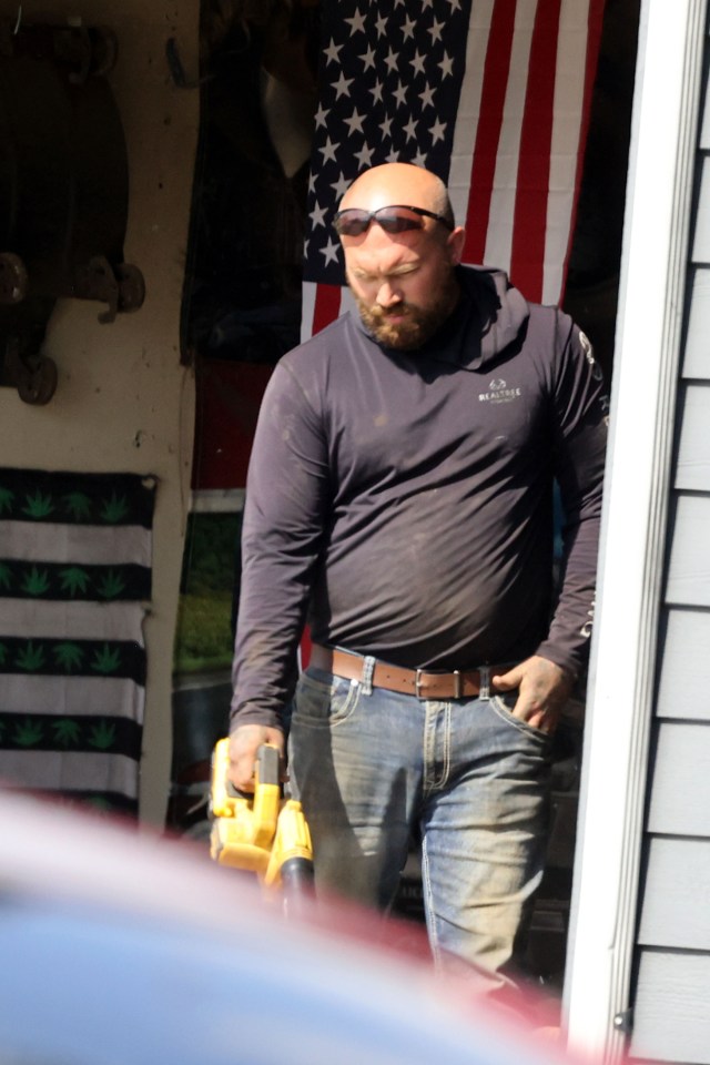 Adam Lind, Teen Mom star, using a leaf blower outside his home.
