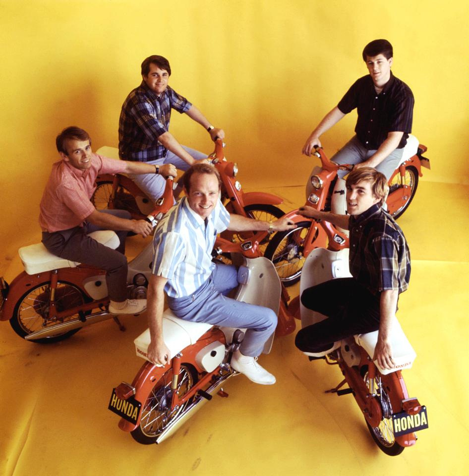 The Beach Boys posing with Honda mopeds.