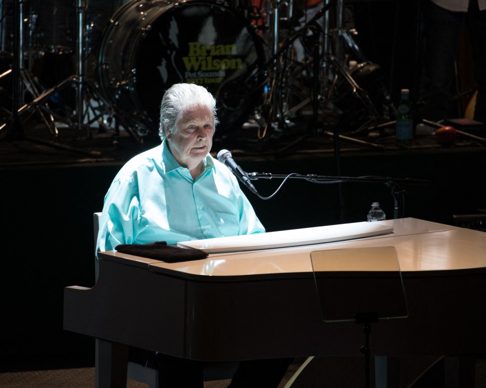 Brian Wilson of the Beach Boys performing at a concert.