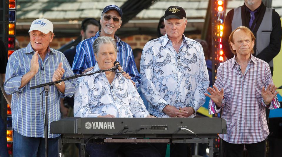 The Beach Boys performing at a concert.