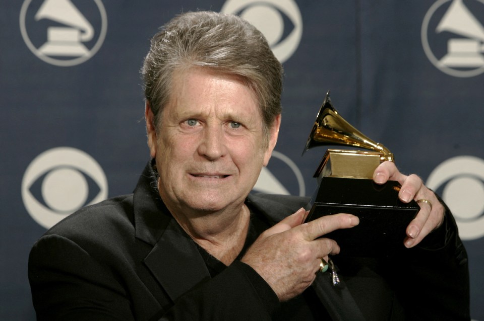 Brian Wilson holding a Grammy Award.