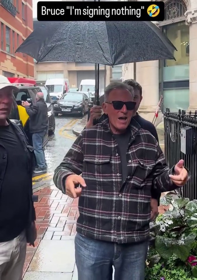 Bruce Springsteen refusing to sign autographs in the rain.