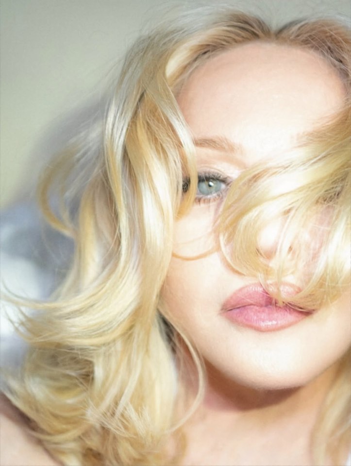 Close-up of Madonna's face partially obscured by her blonde hair.