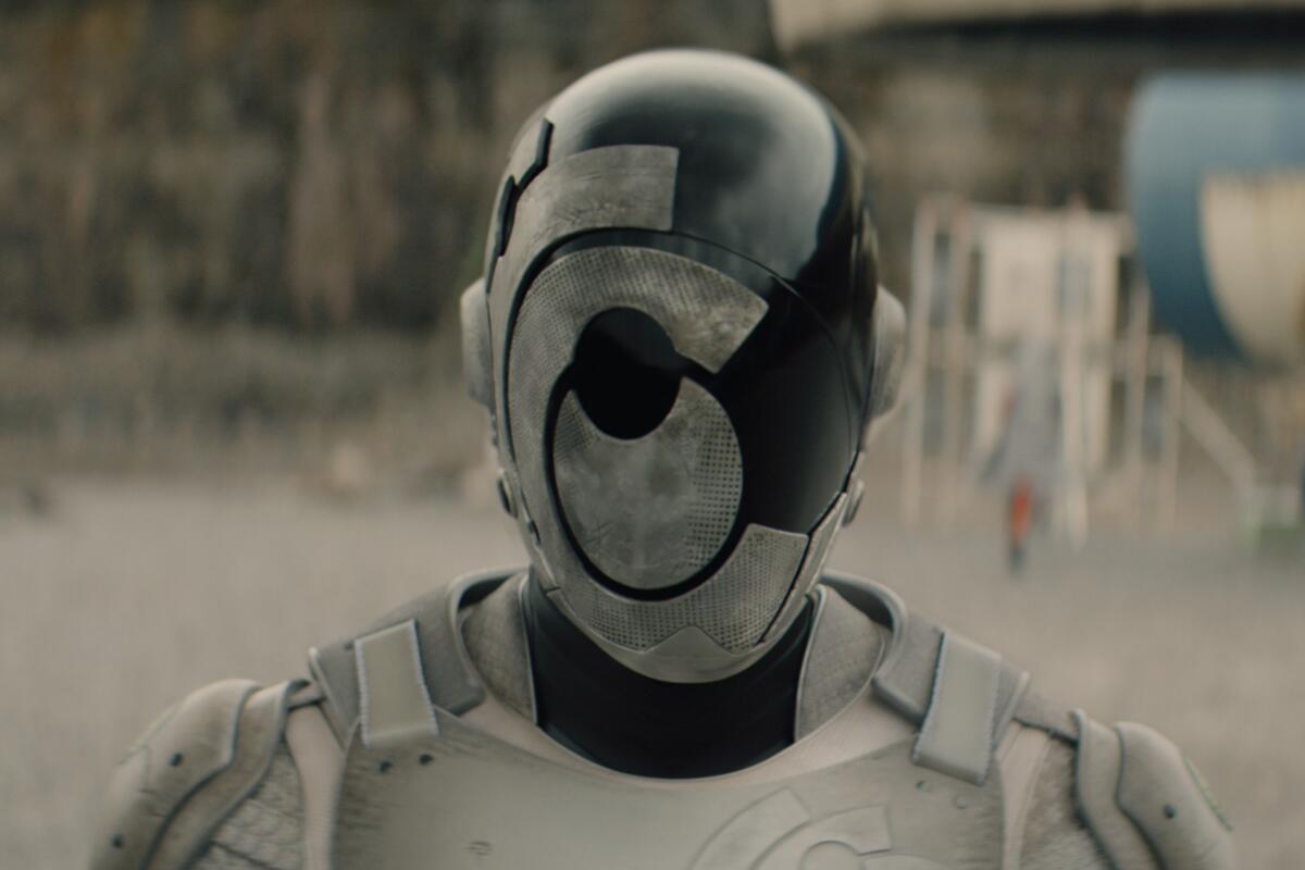 A black and white robot with face armor that looks like a target.