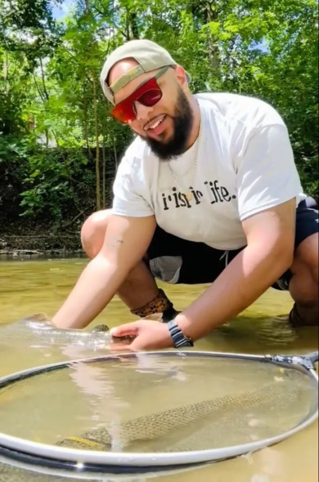 Man holding a fish in a net.