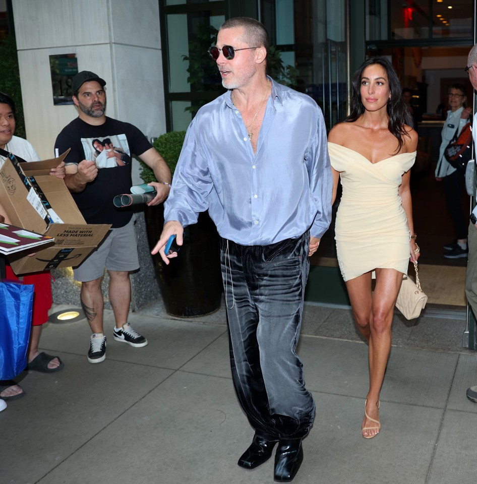 Brad Pitt and Ines de Ramon walking together in New York City.