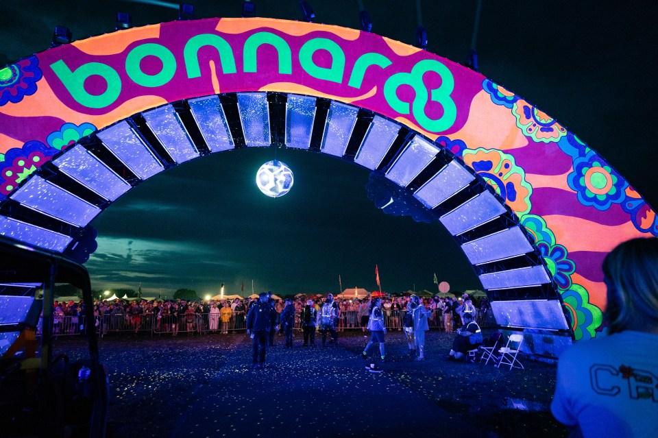 Disappointed Bonnaroo festival attendees at the festival arch after cancellation due to rain.
