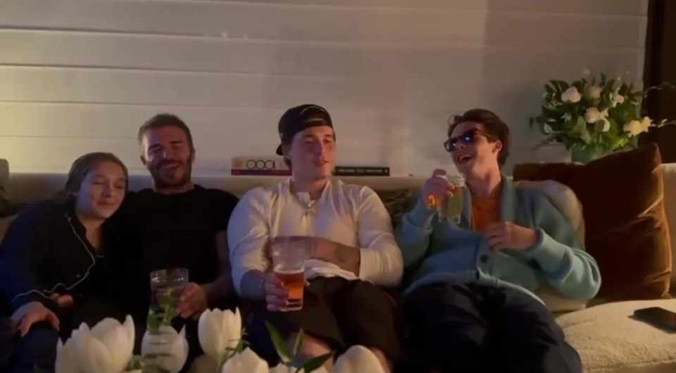 David Beckham and his three eldest children relaxing on a sofa together.