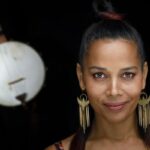 Closeup photo of a woman with a banjo in the background