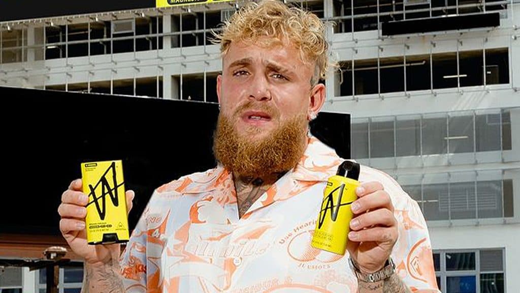 Jake Paul holds up his own brand of men's hygiene products, W by Jake Paul.