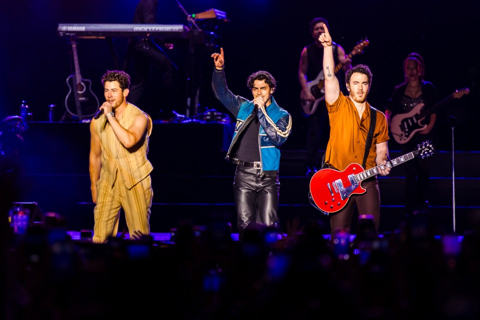 The Jonas Brothers performing on stage.