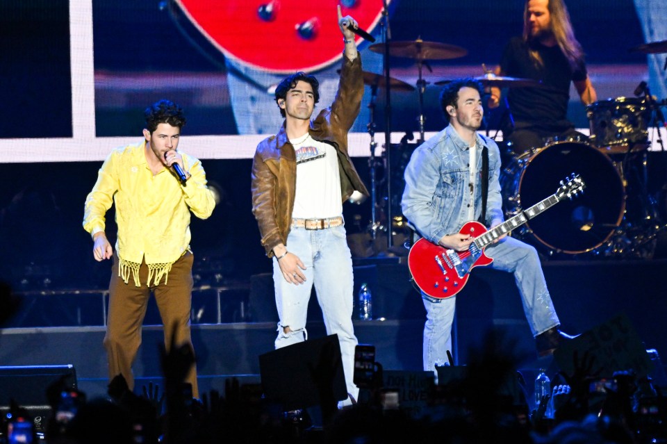 The Jonas Brothers performing onstage.