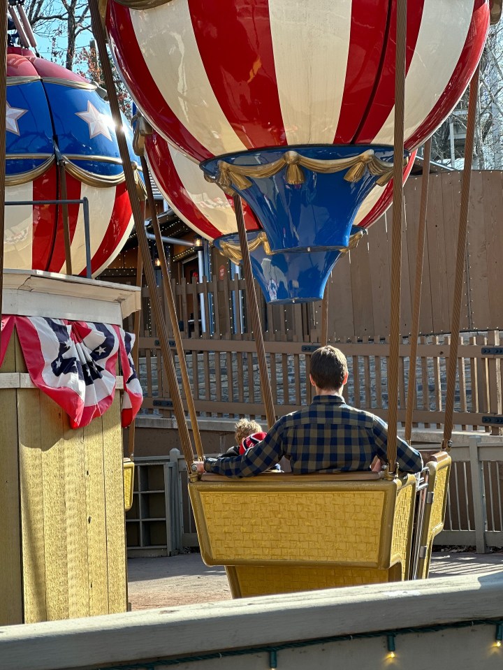 Man and child on a hot air balloon ride.