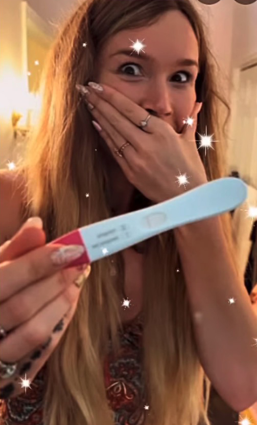 Joss Stone holding a positive pregnancy test.
