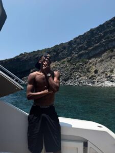 Man on a boat looking out at the ocean.