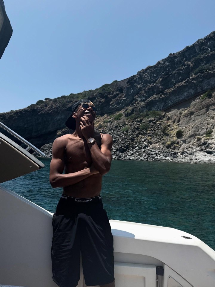 Man on a boat looking out at the ocean.