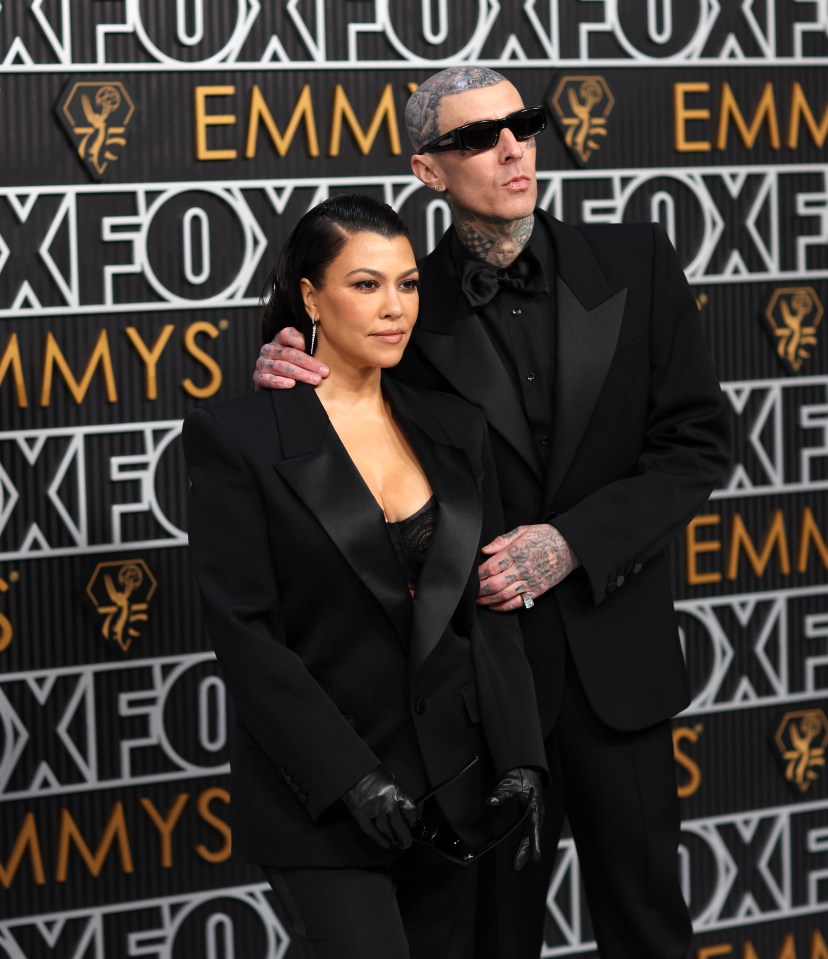 Kourtney Kardashian and Travis Barker arriving at the Emmy Awards.