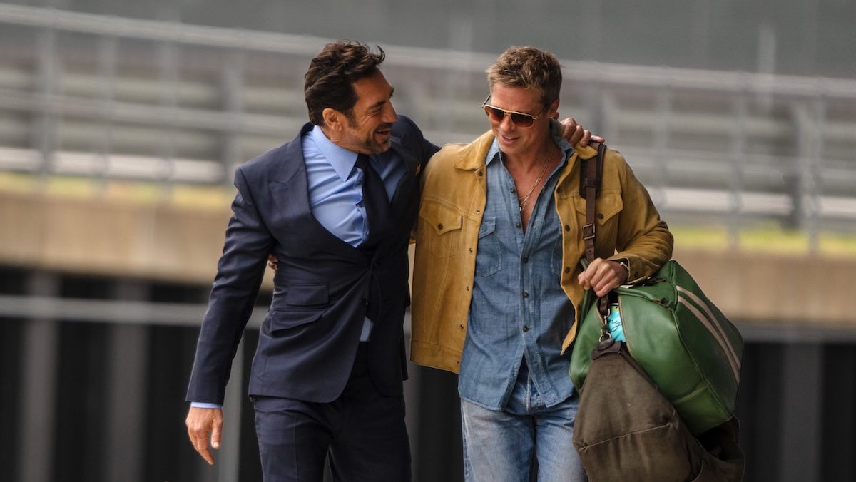 Javier Bardem hugs Brad Pitt as they walk in F1