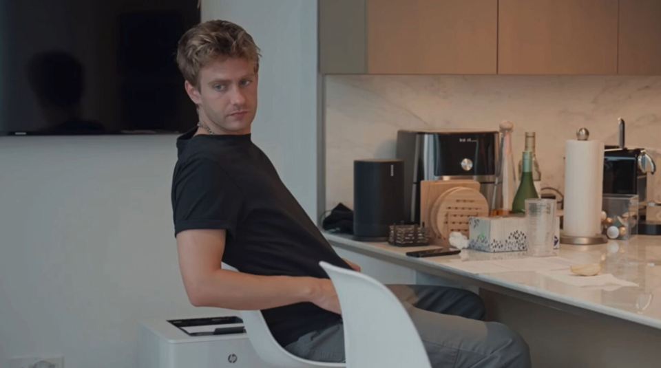 Man sitting at a kitchen counter.