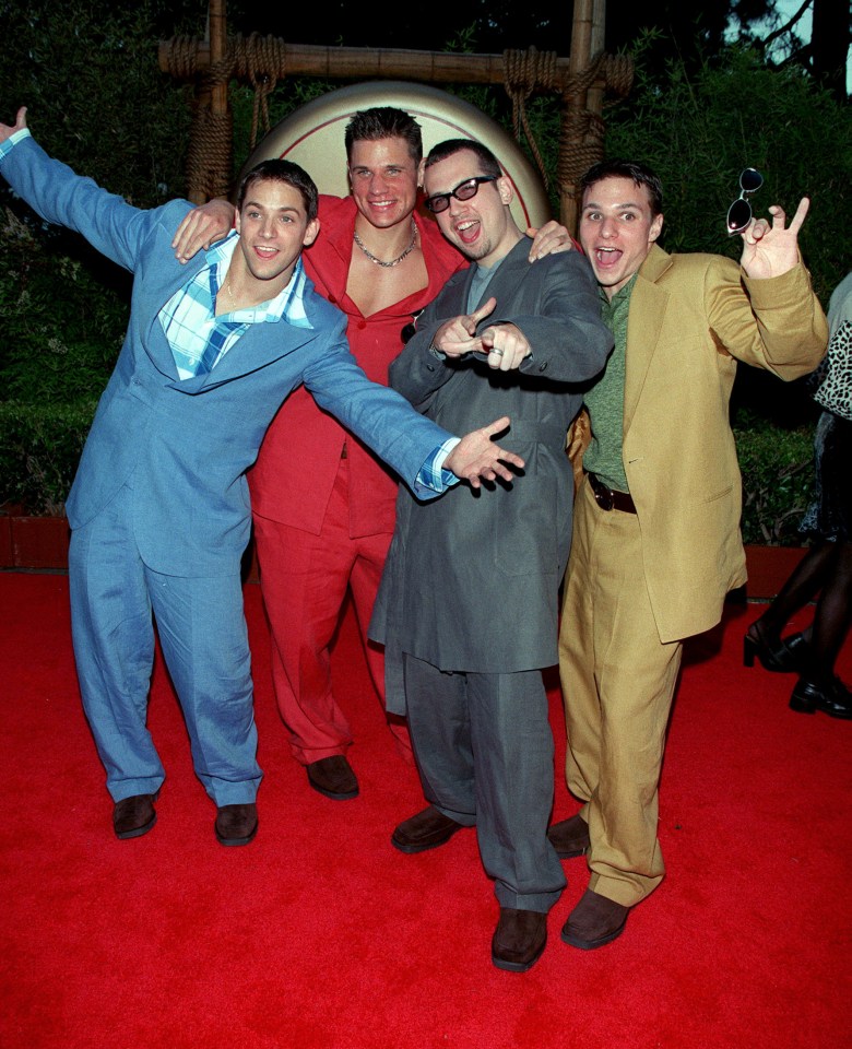 Photo of the band 98 Degrees on a red carpet.