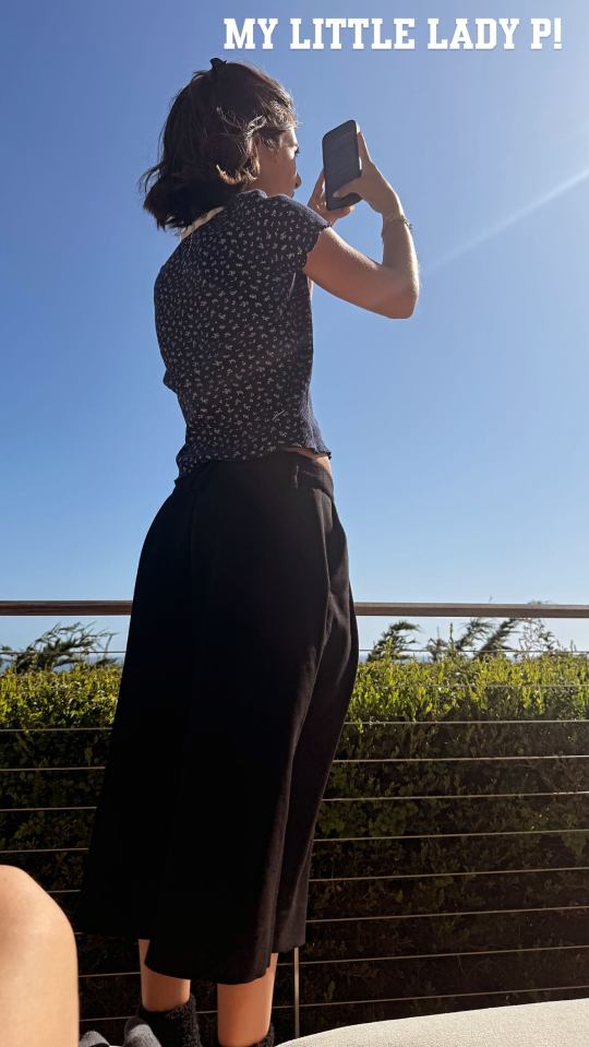 Penelope Disick taking a picture with her phone.