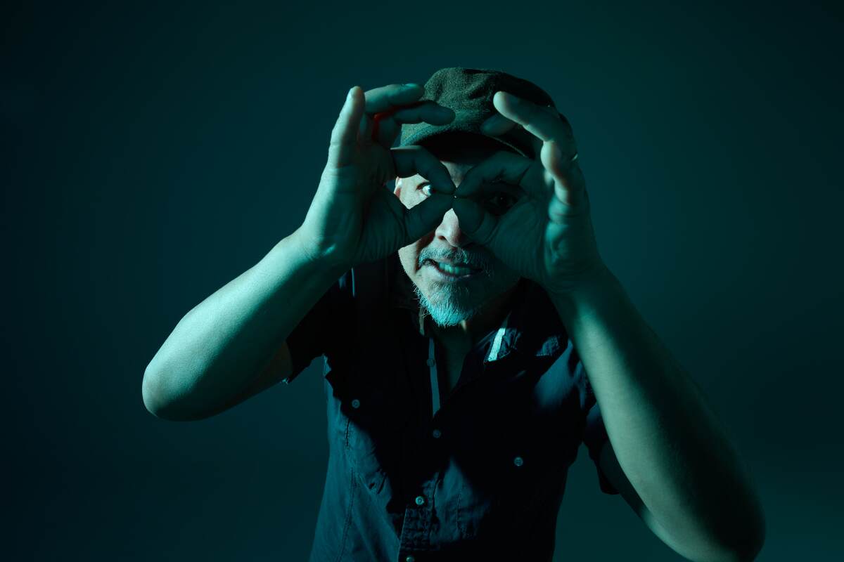 Joey Santiago of the Pixies poses close to the camera lens.
