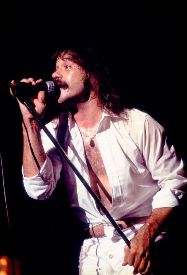 Terry Luttrell of Starcastle performing on stage.