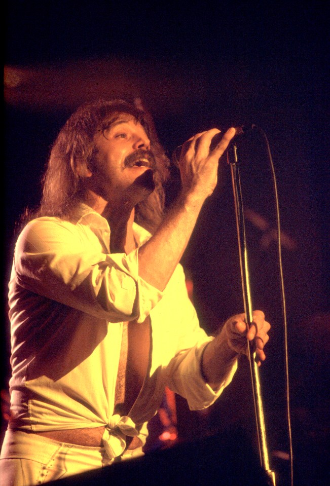Terry Luttrell of Starcastle performing on stage.