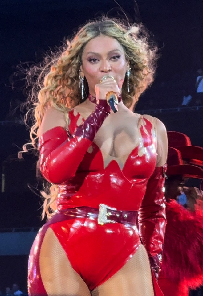 Beyoncé performing in a red bodysuit.