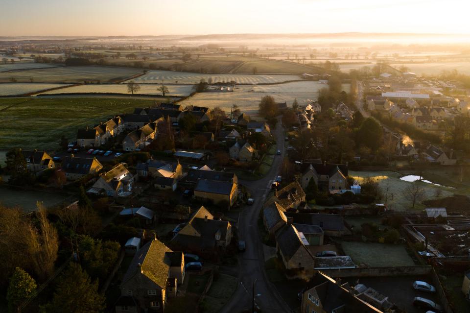 Aerial view of Cotswold village at sunrise.