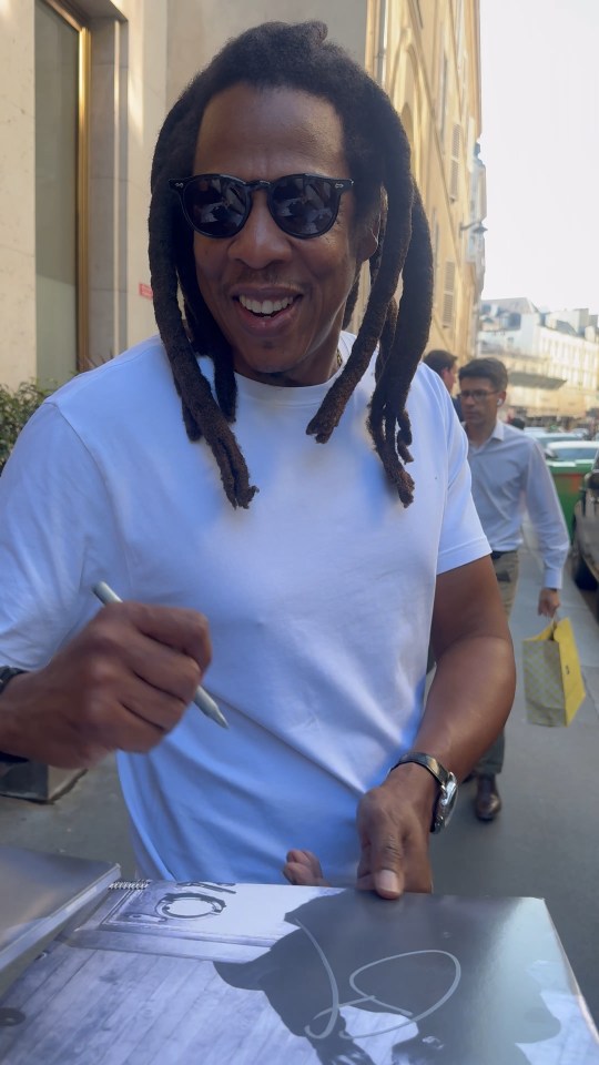Jay-Z signing an autograph in Paris.