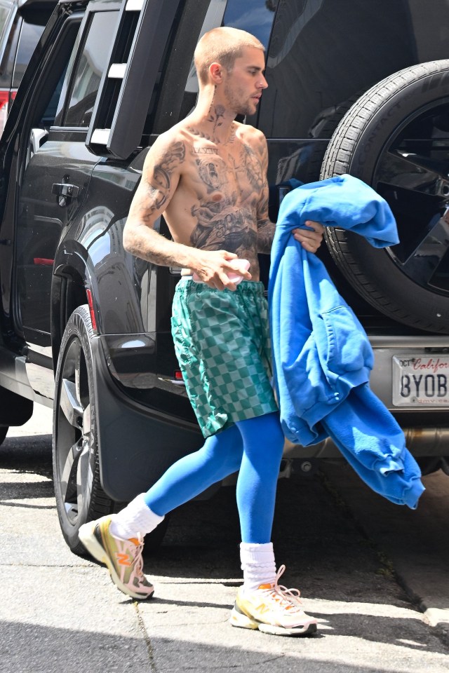Justin Bieber walking near a car.