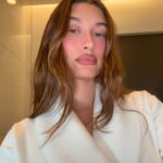 Hailey Bieber in a white robe.
