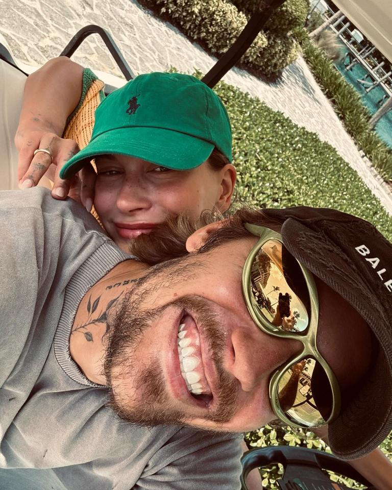 Justin and Hailey Bieber in a golf cart.