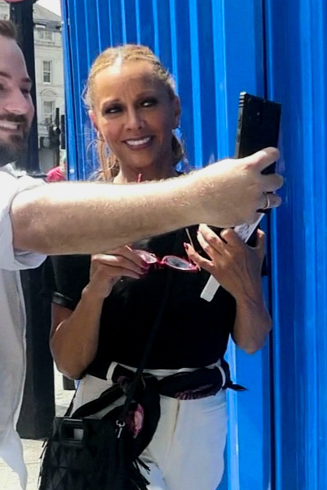 Vanessa Williams taking selfies with fans.