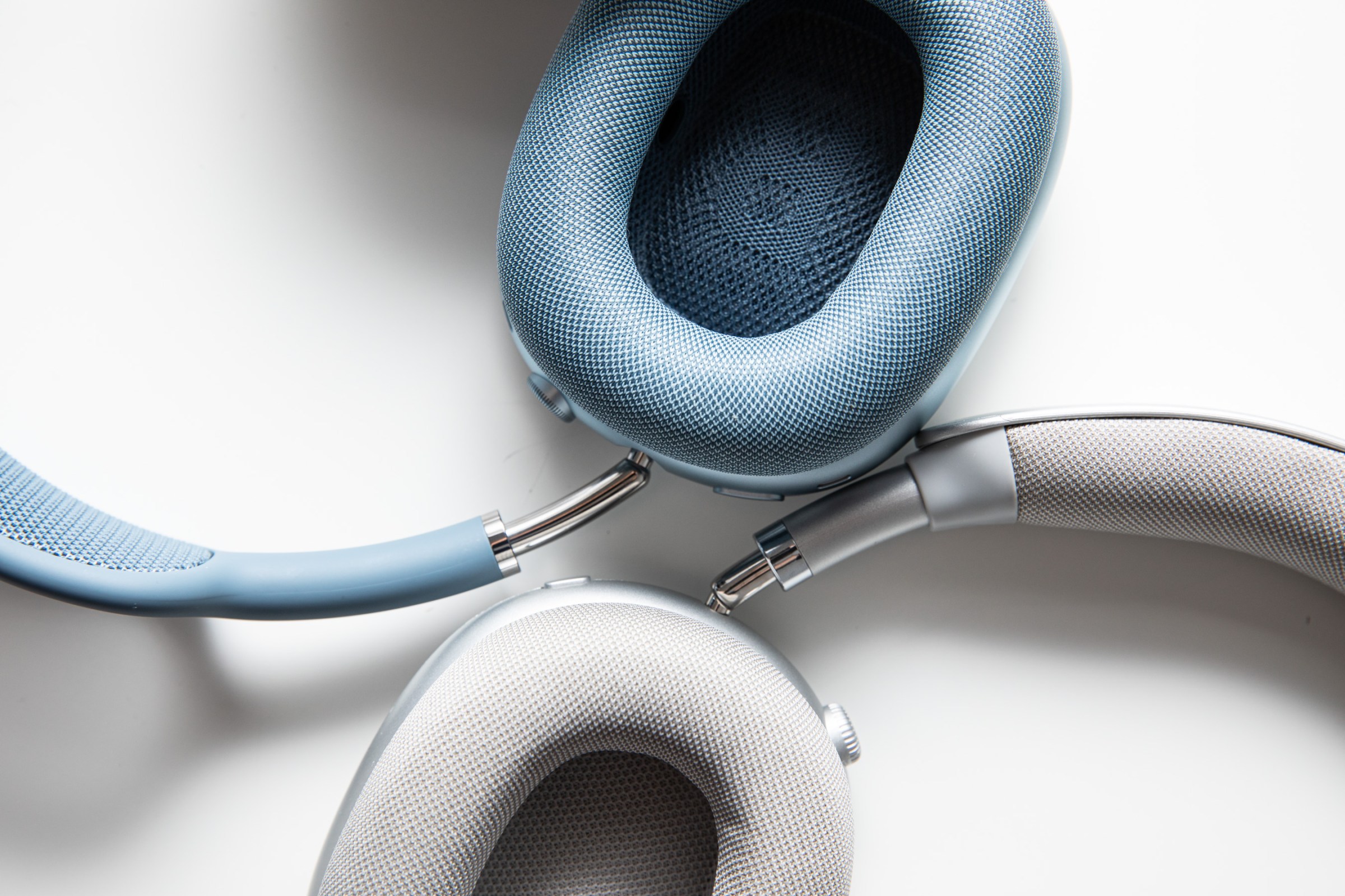 Two earcups, in different colors, from two sets of headphones.