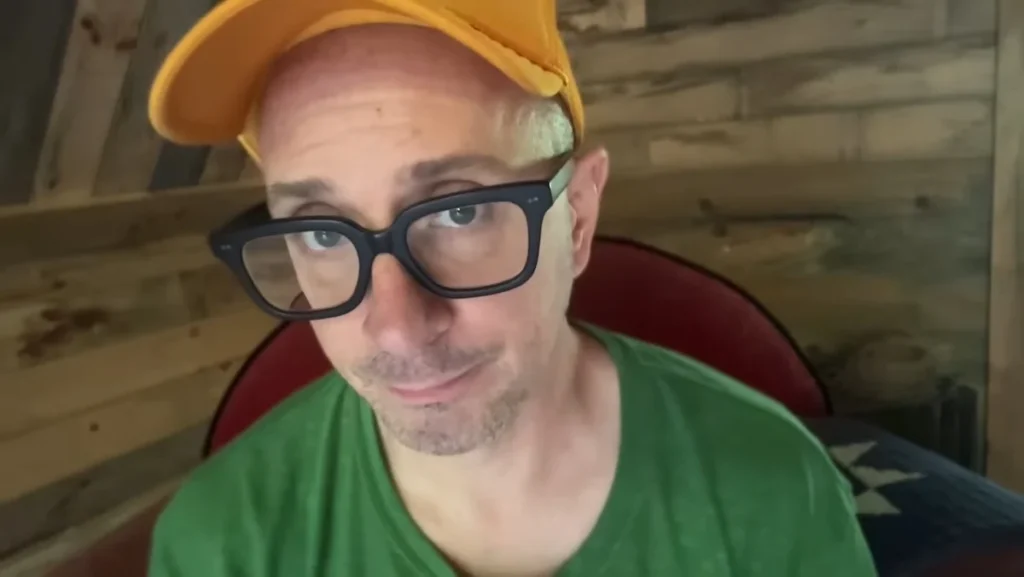 Steve Burns in a yellow hat and black rimmed glasses